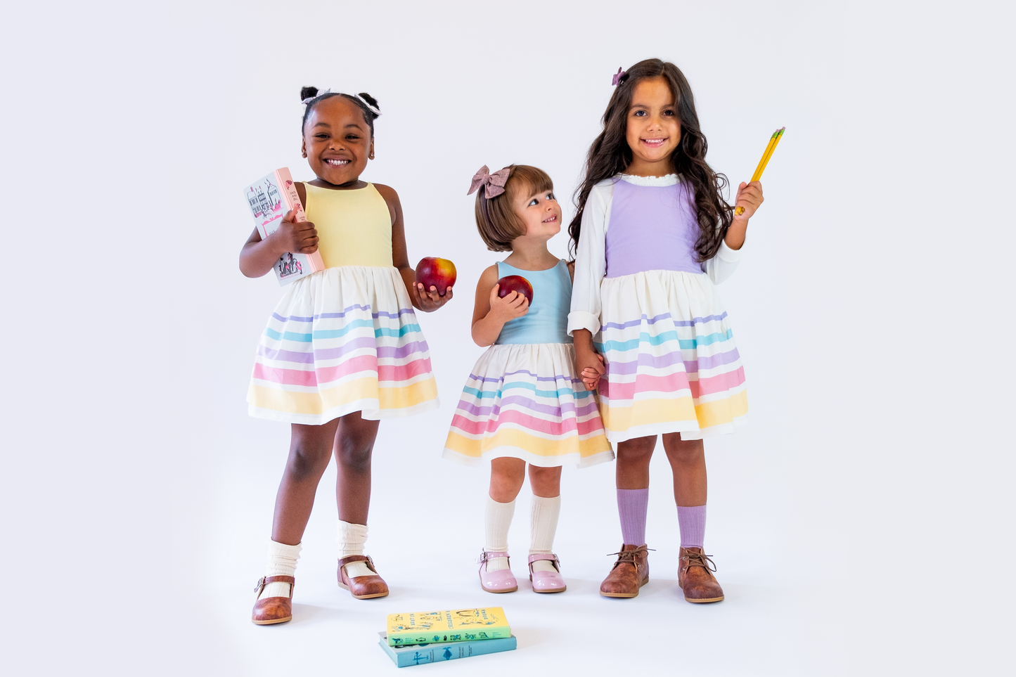 Three friends getting with back to school supplies wearing the pastel shorties