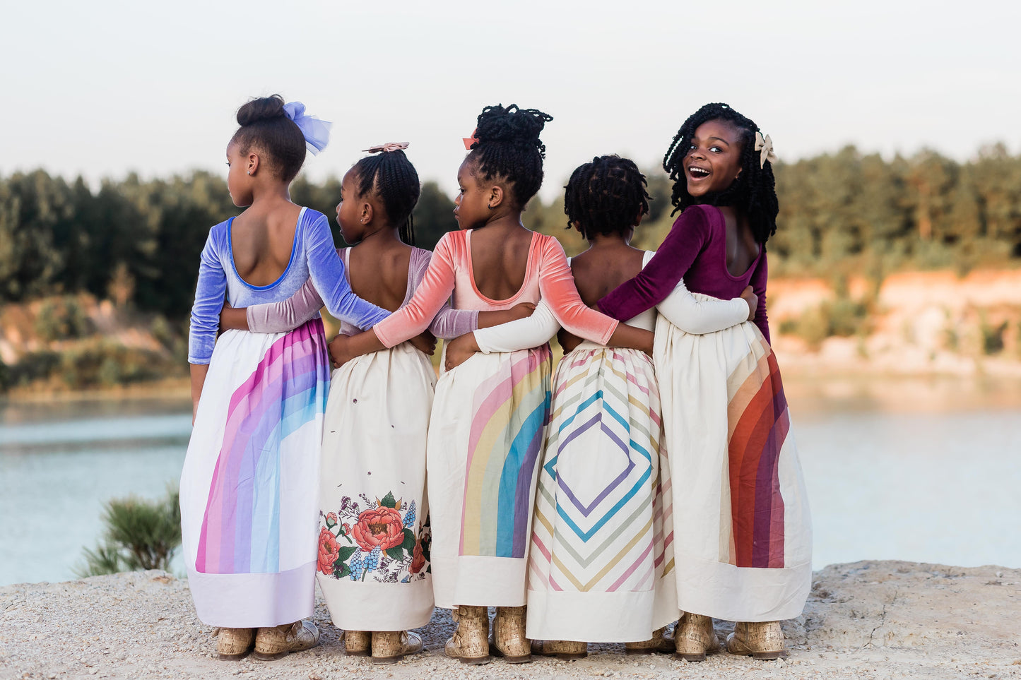 five friends with linked arms facing forward. They are all wearing the Fall dress collection