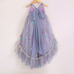Back of a Pleiades Designs high low dress with embroidered stars, periwinkle chiffon, a ruffle hem, and a bow back