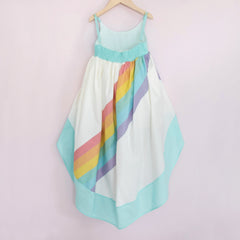 White and aqua high low dress with a bright rainbow across the back
