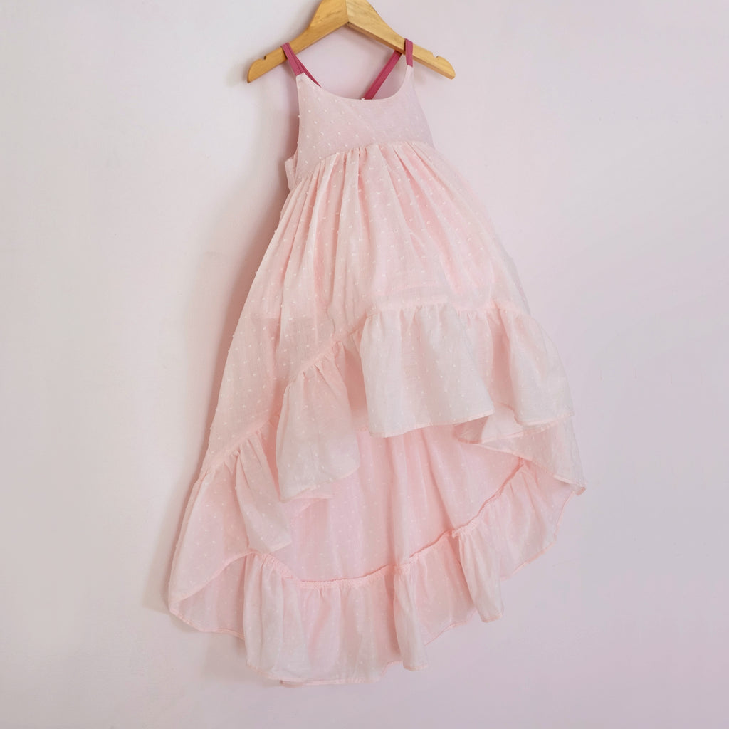 Front of a Pleiades Designs pink clip dot cotton high low dress with a ruffle hem