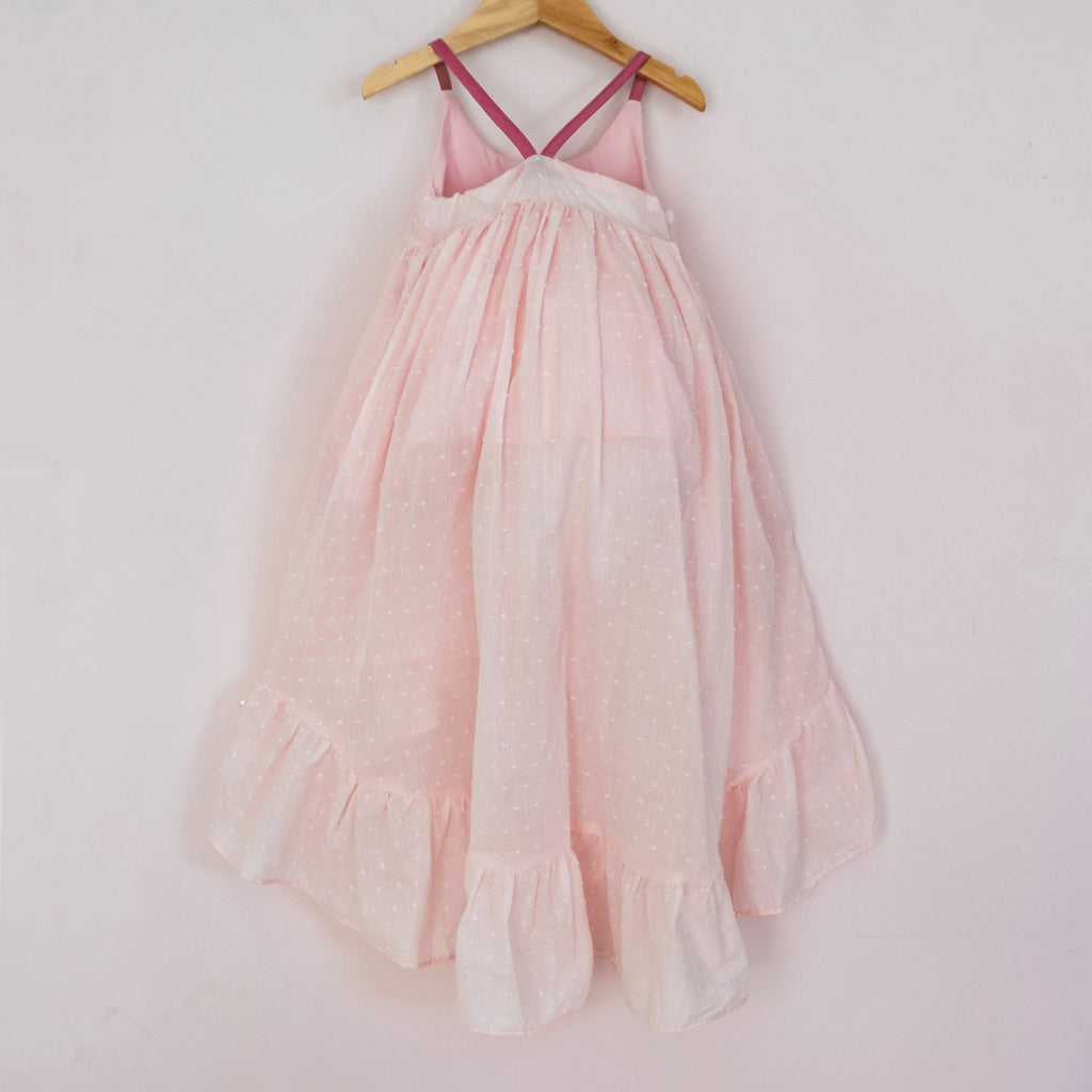 Back of a Pleiades Designs pink clip dot cotton high low dress with a ruffle hem
