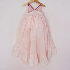 Back of a Pleiades Designs pink clip dot cotton high low dress with a ruffle hem