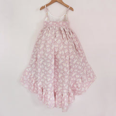 Back of a Pleiades Designs pink high low dress with a ruffle hem and a daisy pattern