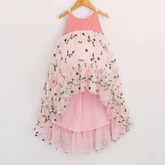 Front of a Pleiades Designs pink high low dress with a pink velvet bodice, embroidered rosebud design, and a rufffle hem