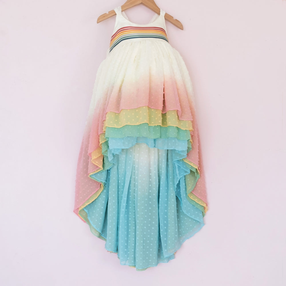 
                  
                    Front of a Pleiades Designs clip dot high low dress with a rainbow ombre skirt and a rainbow stripe bodice
                  
                