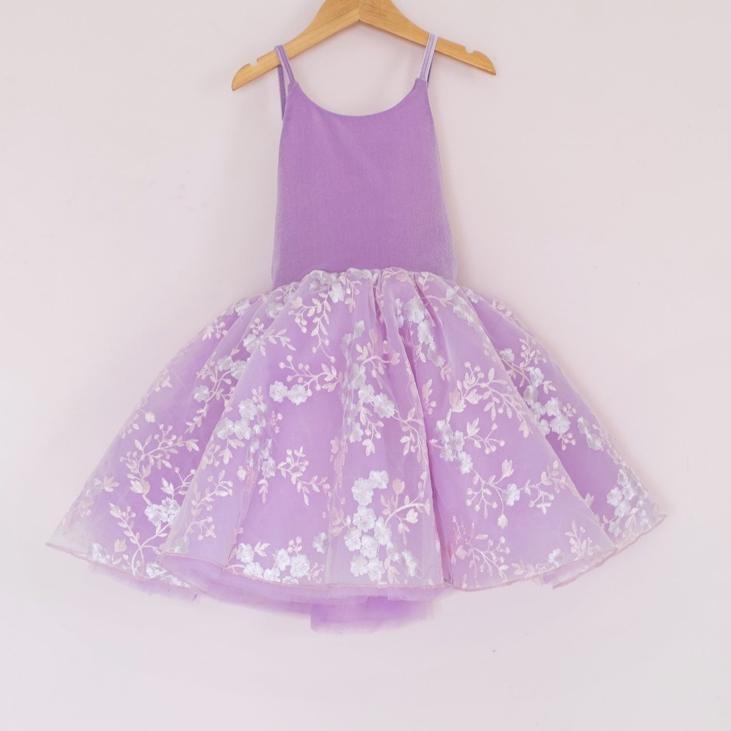 Front of a Pleiades Designs purple tulle dress with an embroidered floral layer and a purple velvet bodice
