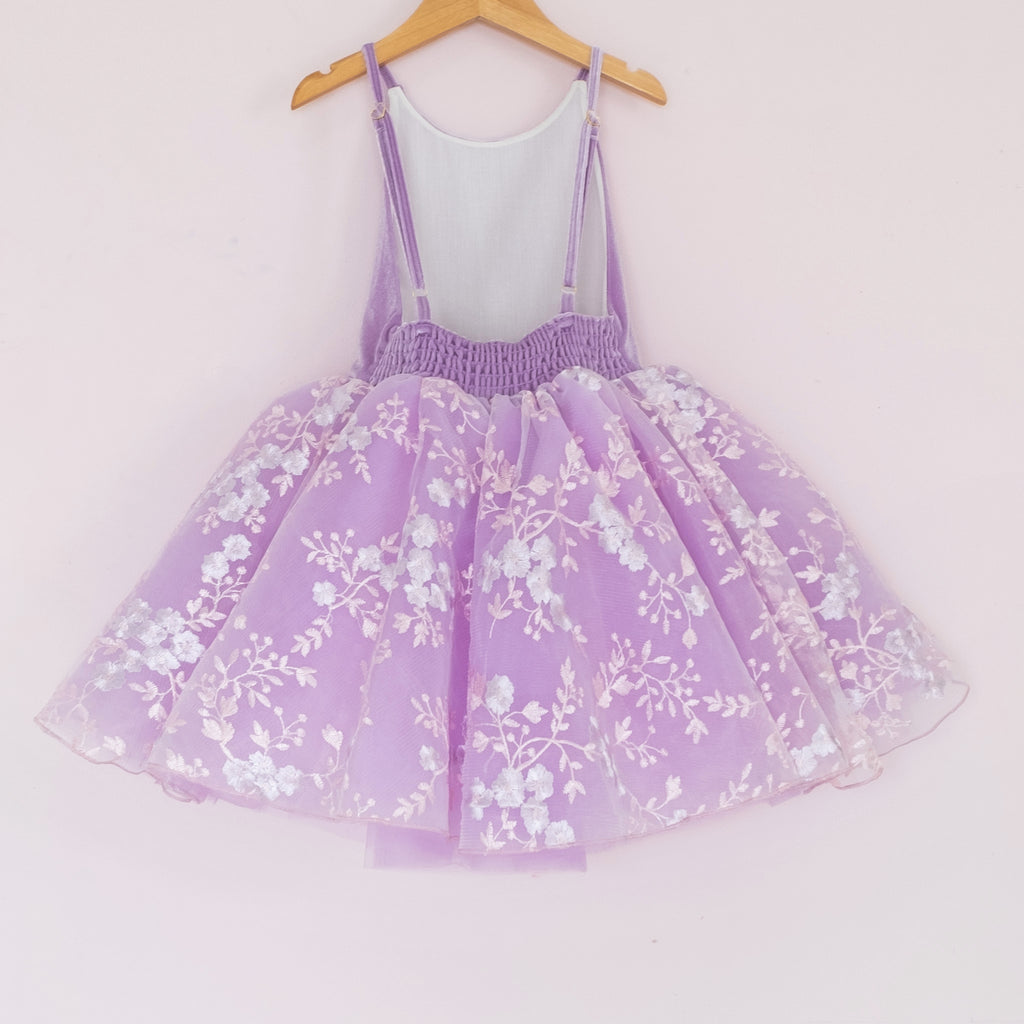 Back of a Pleiades Designs purple tulle dress with an embroidered floral layer and a purple velvet bodice