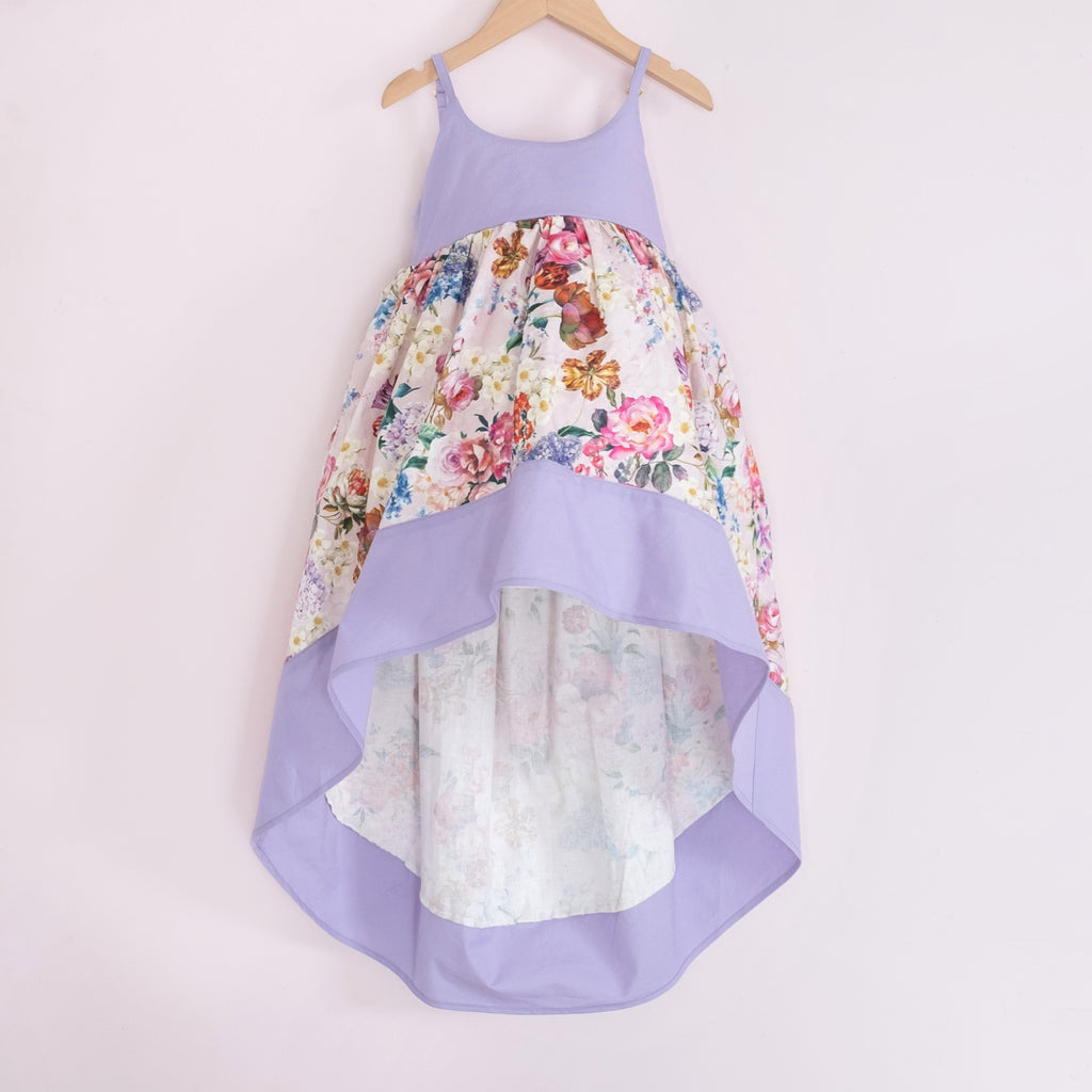 Front of a Pleiades Designs high low dress with a spring floral design and a matching purple bodice & hem