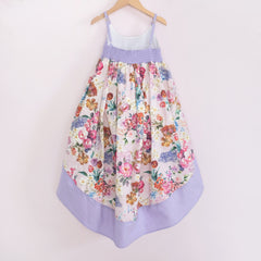 Back of a Pleiades Designs high low dress with a spring floral design and a matching purple bodice & hem