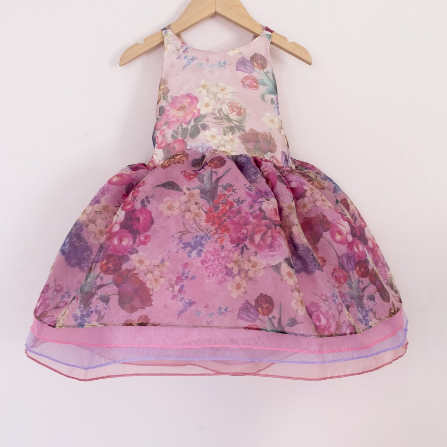 Front of a Pleiades Designs short organza dress with a purple floral pattern