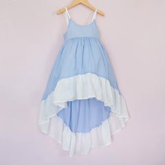 Front of a Pleiades Designs high low dress. Made with a blue and ivory clip dot cotton and a full ruffle hem