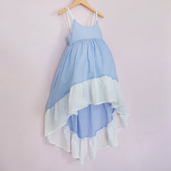 Front of a Pleiades Designs high low dress. Made with a blue and ivory clip dot cotton and a full ruffle hem