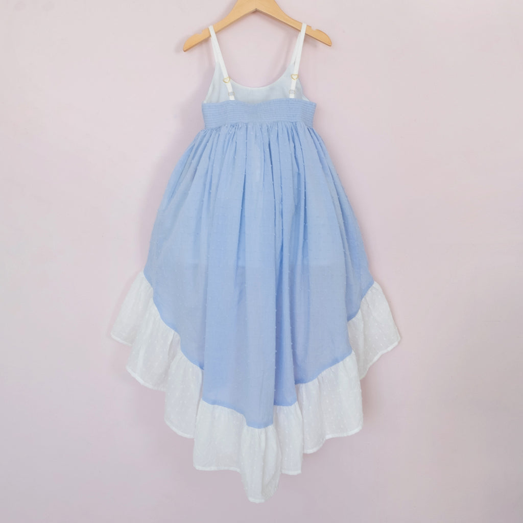 Back of a Pleiades Designs high low dress. Made with a blue and ivory clip dot cotton and a full ruffle hem