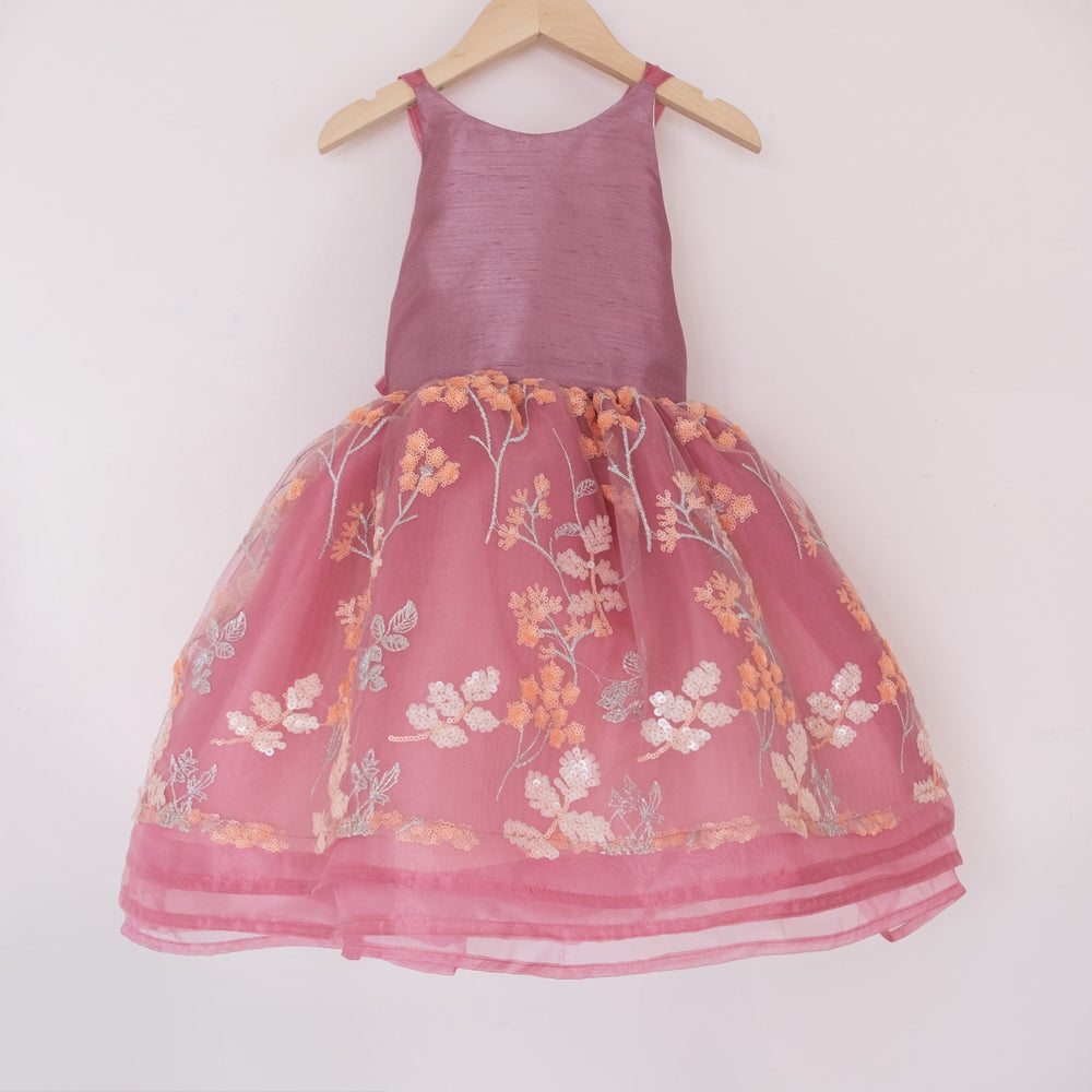 Front of a Pleiades Design short organza dress with an embroidered sequin floral and a faux silk mauve bodice