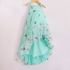 Front of a Pleiades Designs teal high low dress with embroidered florals and a ruffle hem